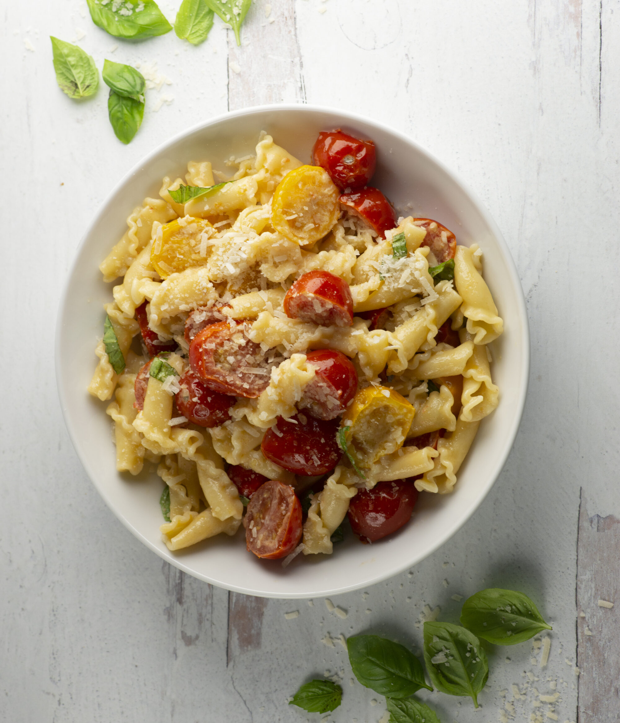Bowl of pasta with fresh tomato basil sauce.