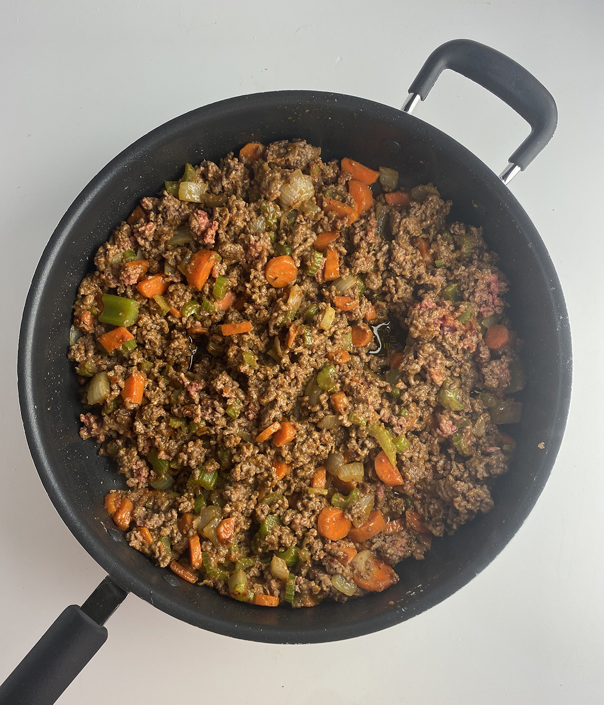 Cooked ground beef in a skillet.