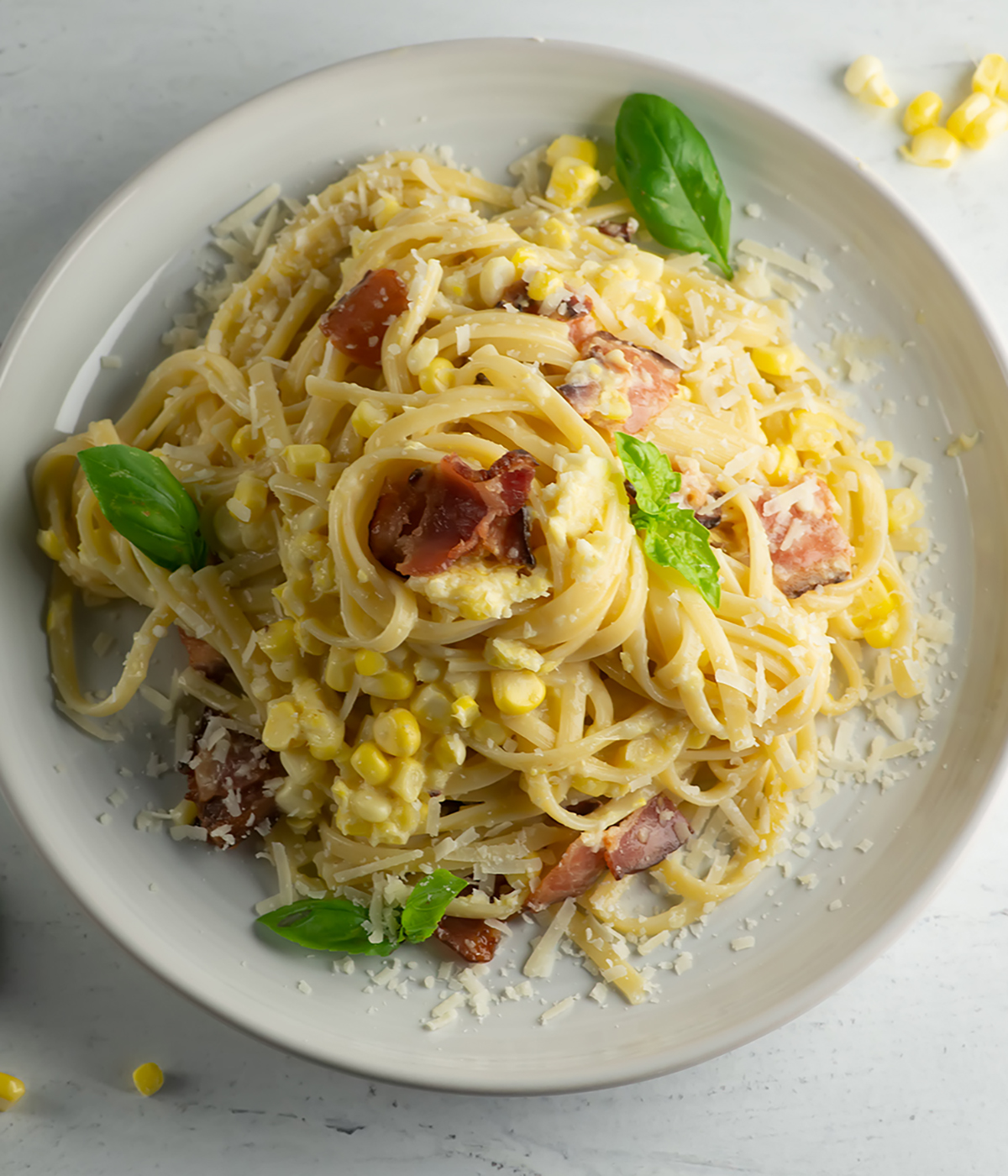Finished corn pasta carbonara on a plate.