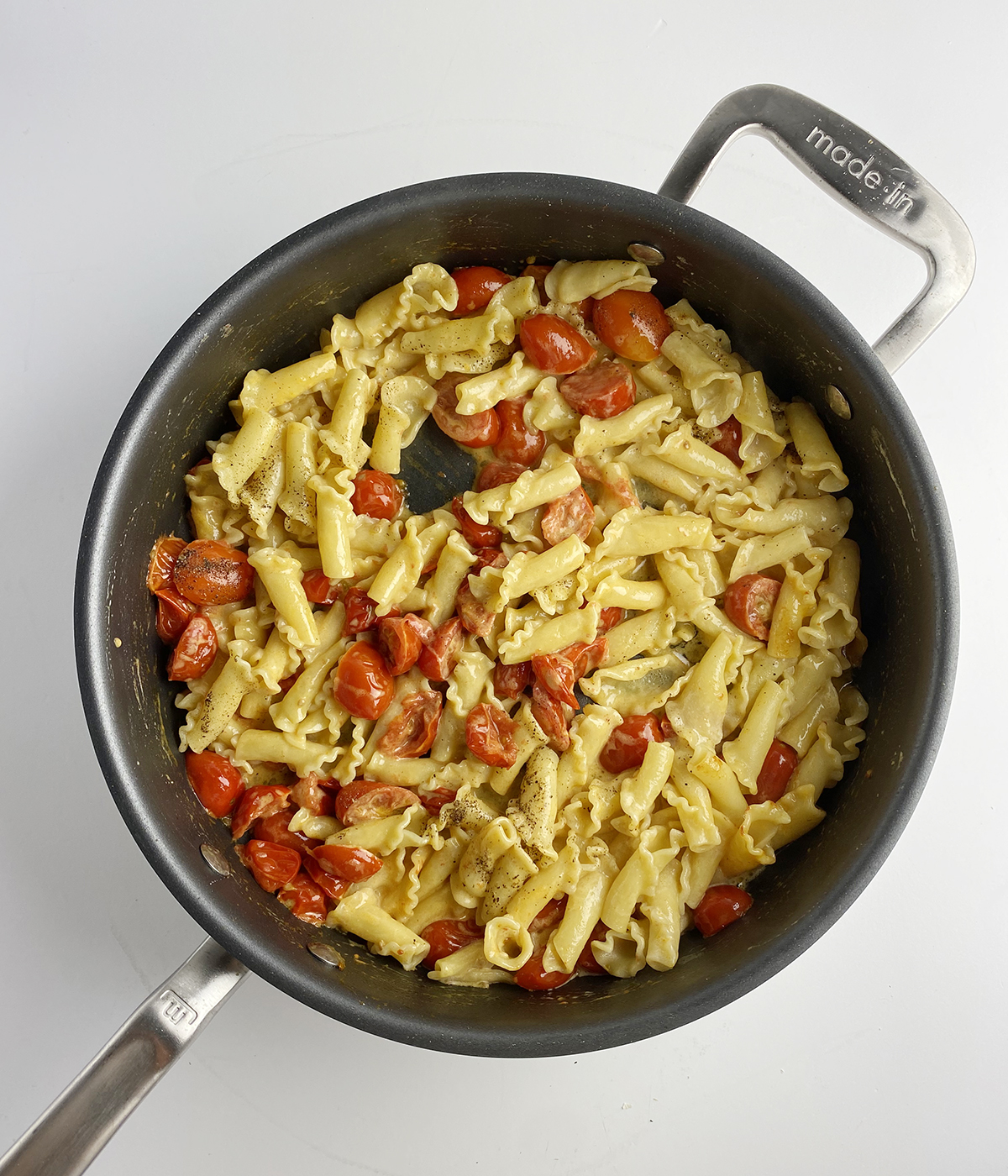 Fresh tomato pasta sauce with pasta in a skillet.