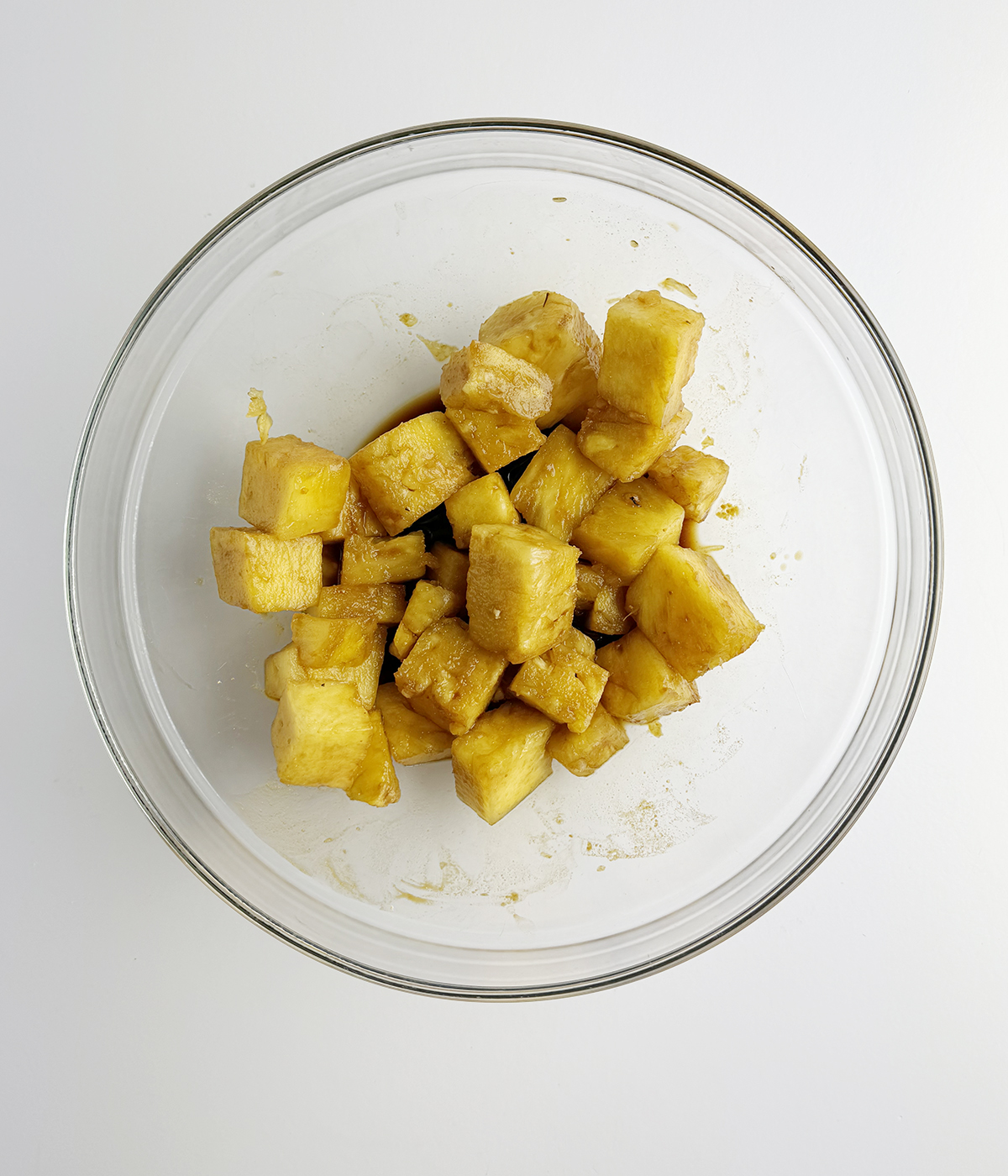 Pineapple marinating in a bowl.
