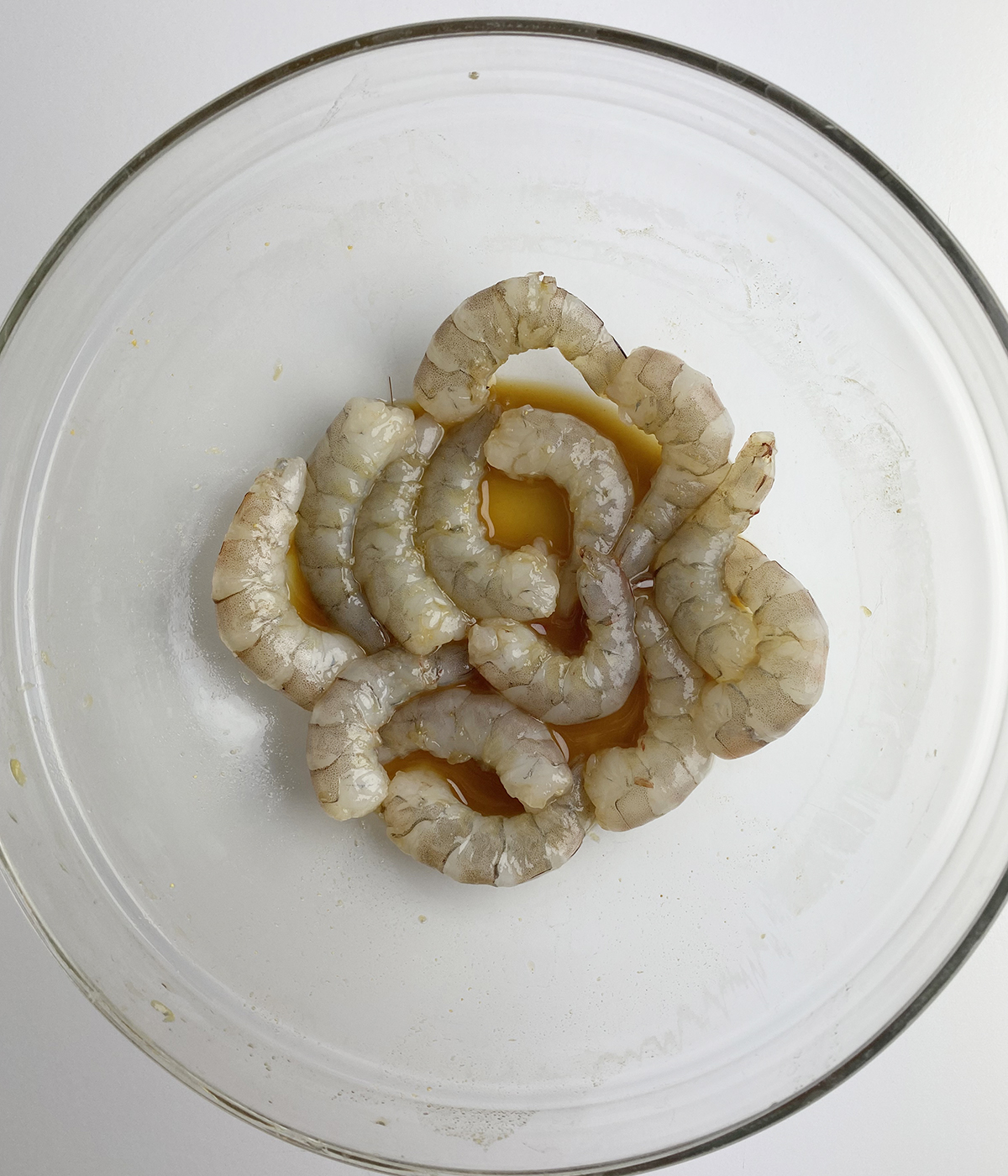 Shrimp marinating in a bowl.