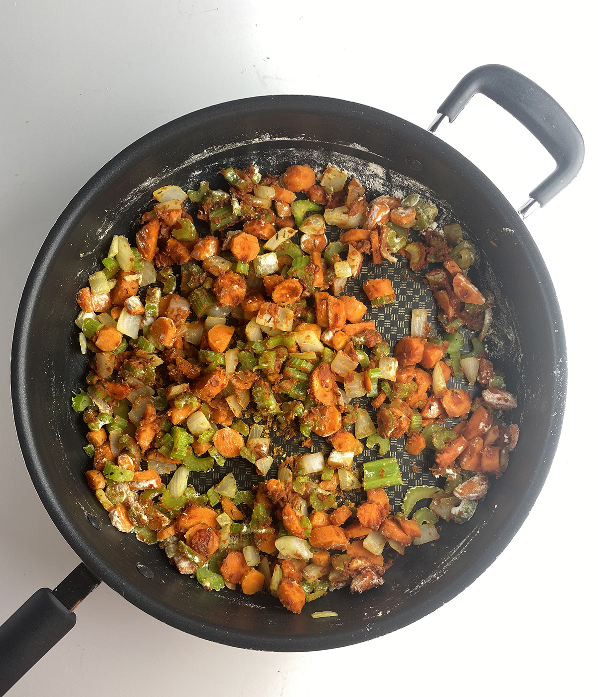 Skillet with cooked vegetables.