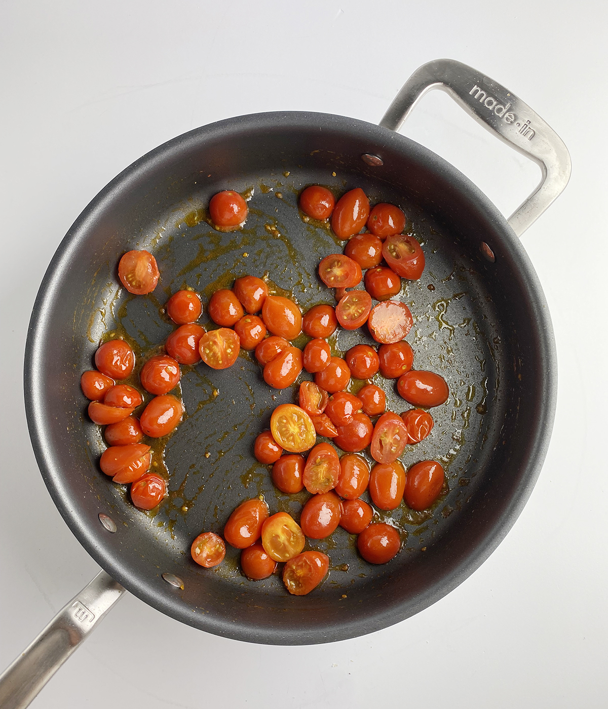 Tomatoes cooking in a skillet.