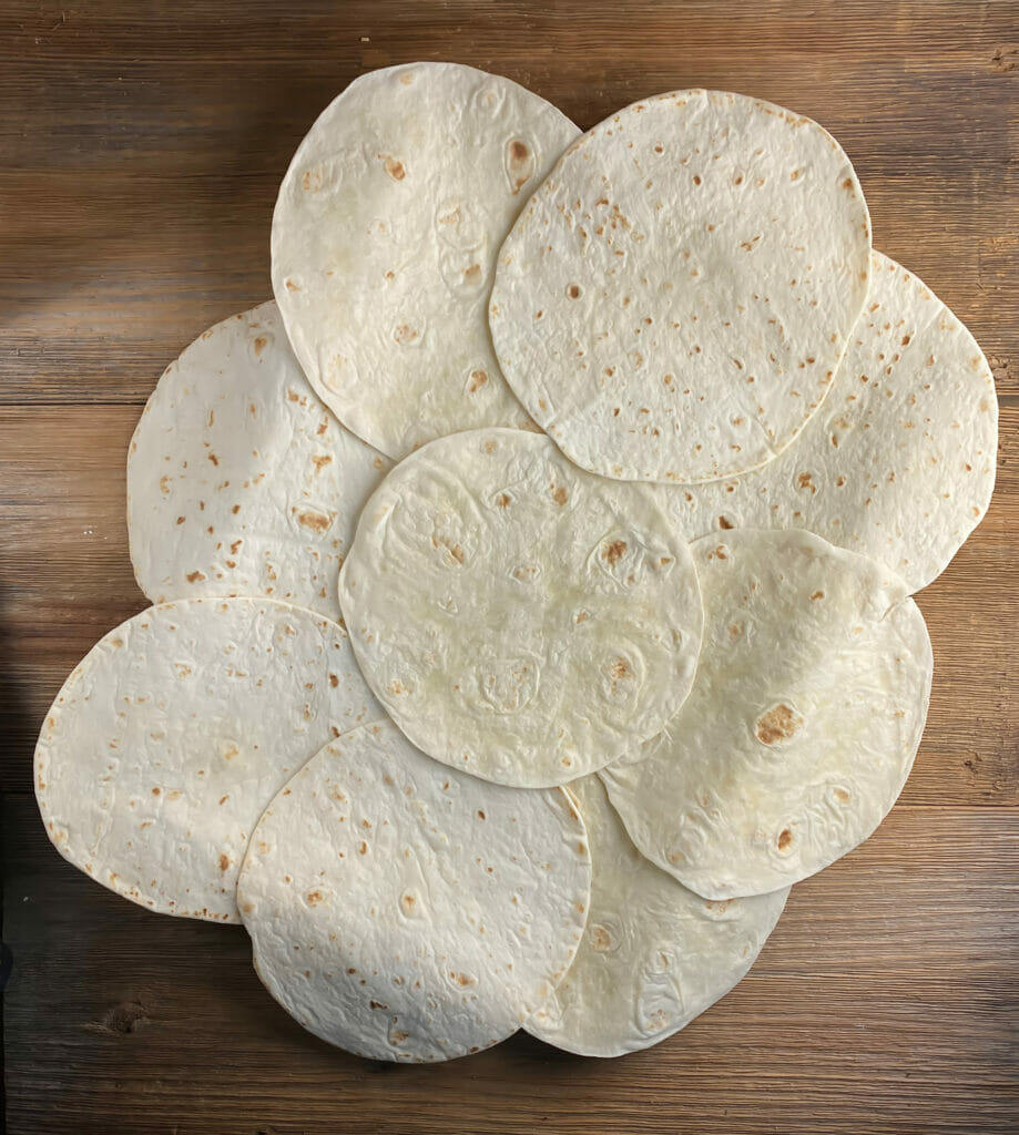 Tortillas laid out on a sheet pan.