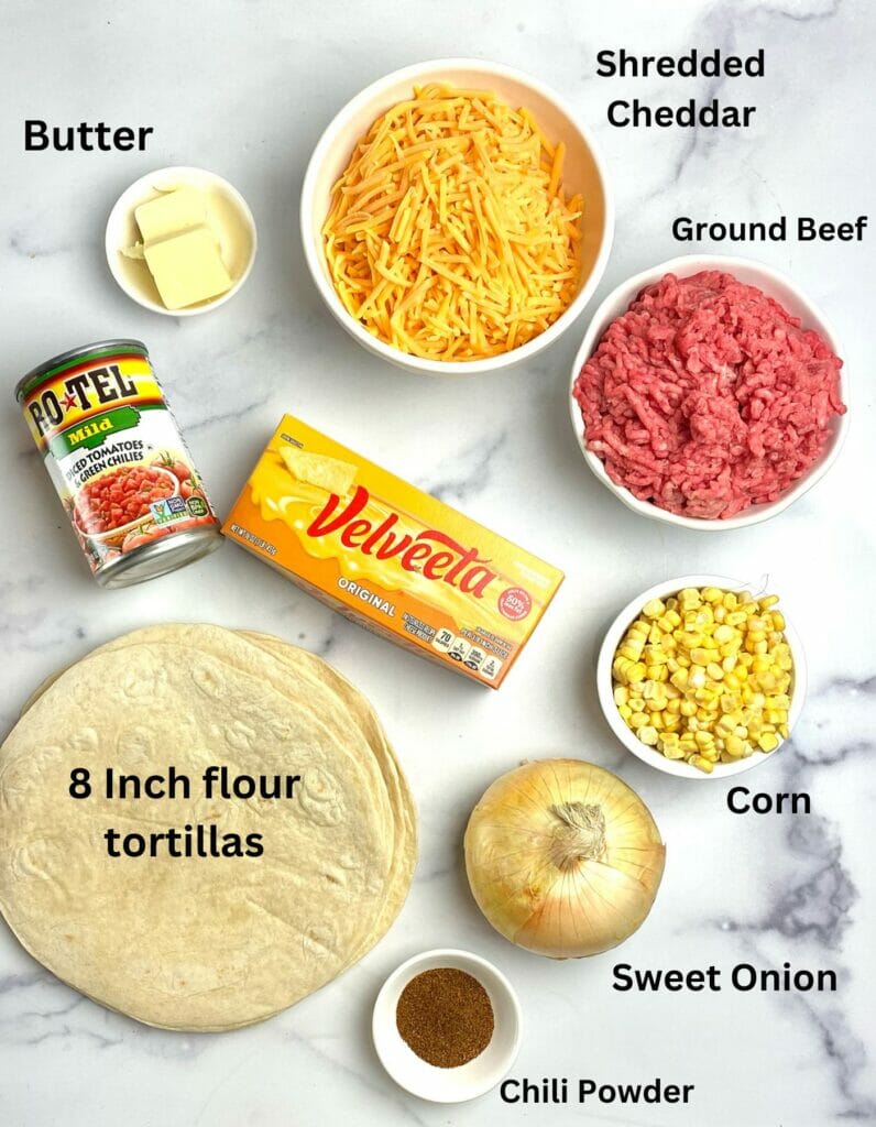 Nacho sheet pan quesadilla ingredients on a marble counter.