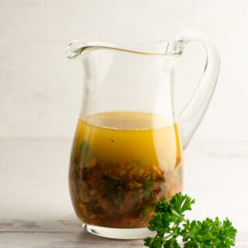 Warm bacon vinaigrette in a pitcher.