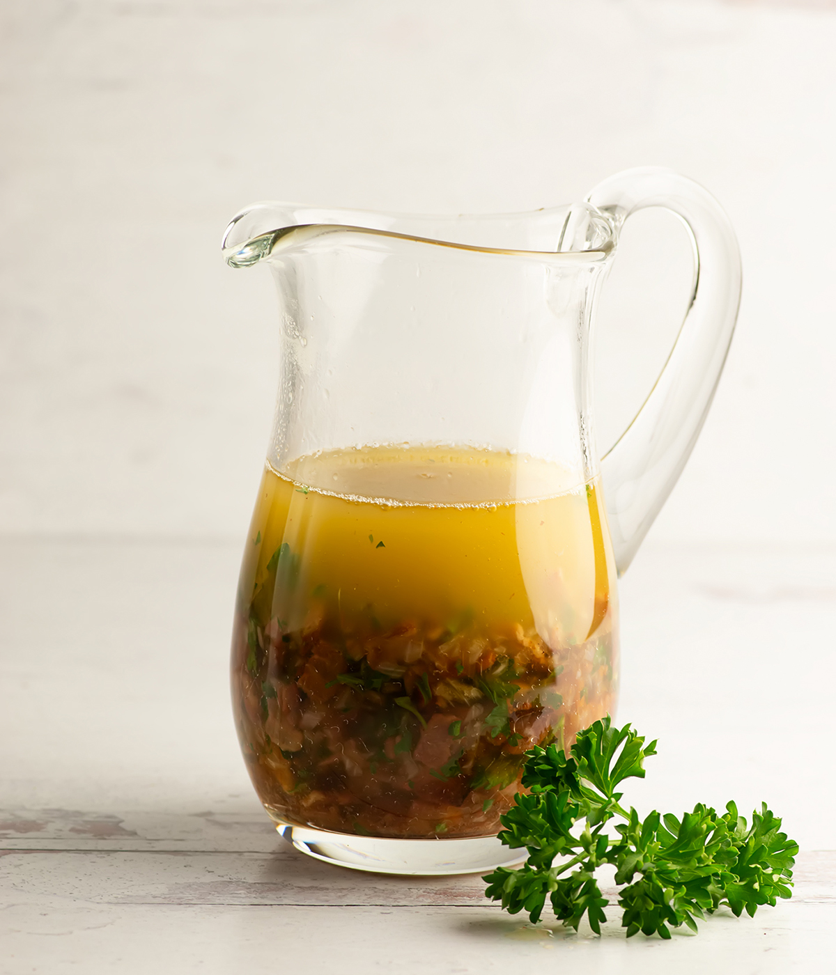 Warm bacon vinaigrette in a pitcher.