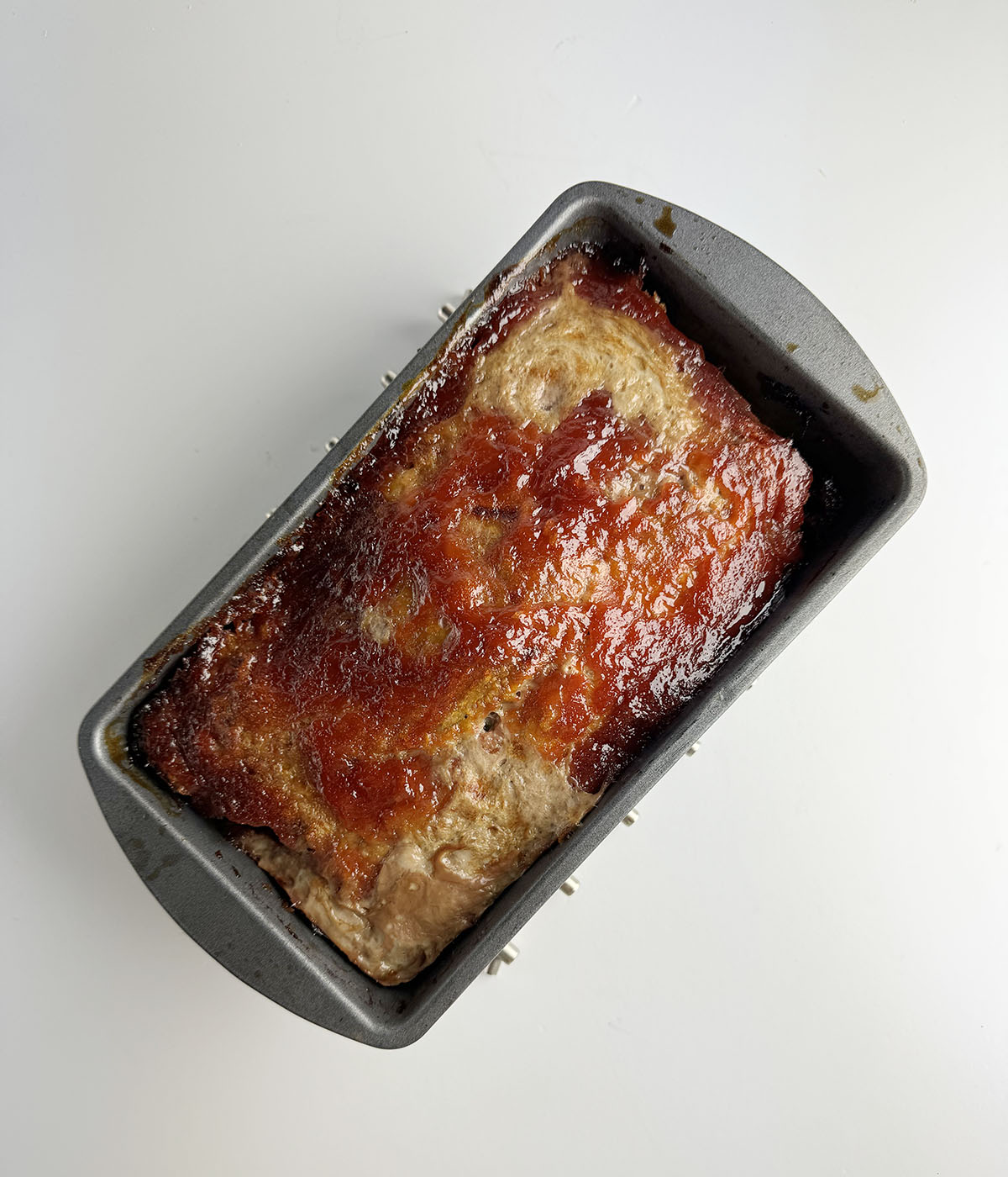Baked meatloaf with ketchup topping.