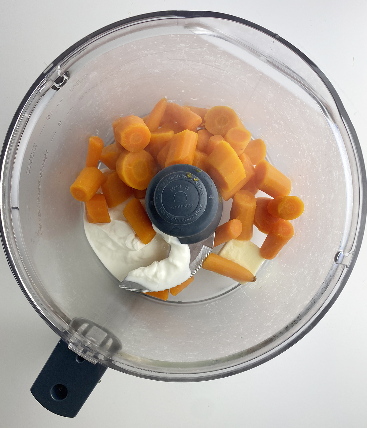 Carrots, butter and sour cream in a food processor.