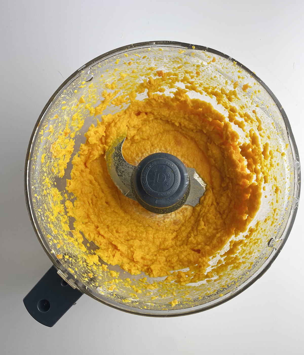 Creamy whipped carrots in a food processor.