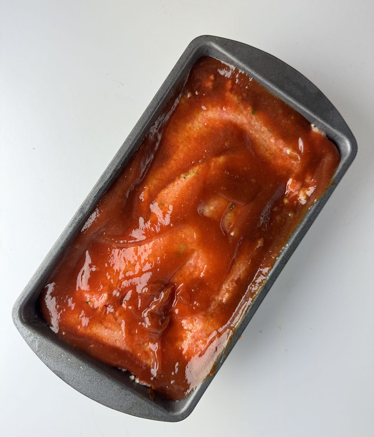 Meatloaf with ketchup ready for the oven.