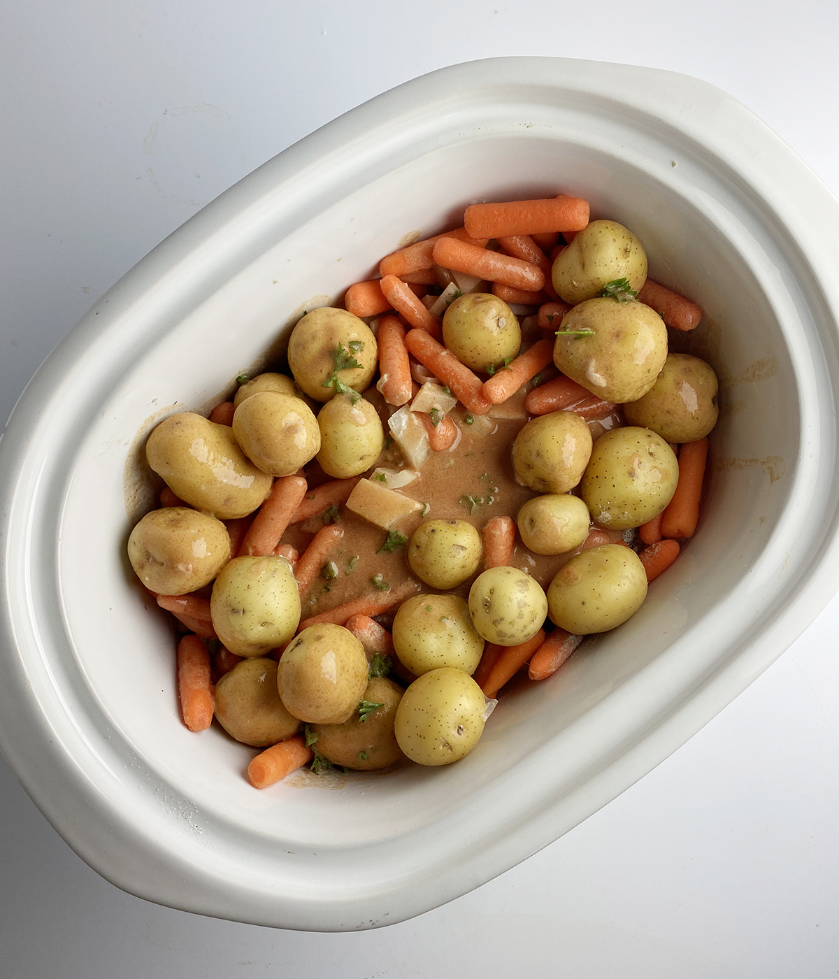 Slow cooker turkey pot roast ingredients in slow cooker ready to be cooked.