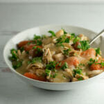 Slow cooker turkey pot roast in a bowl with a spoon.