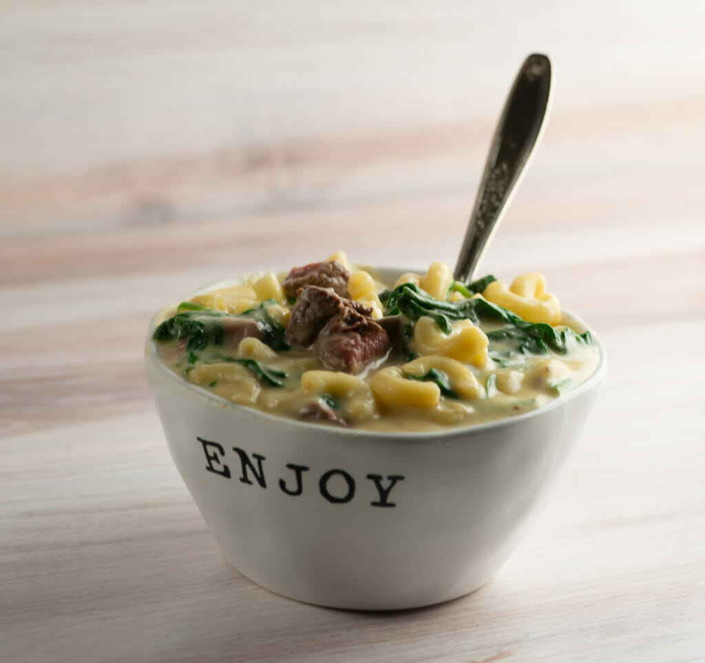 Steakhouse macaroni and cheese in a bowl with a fork.