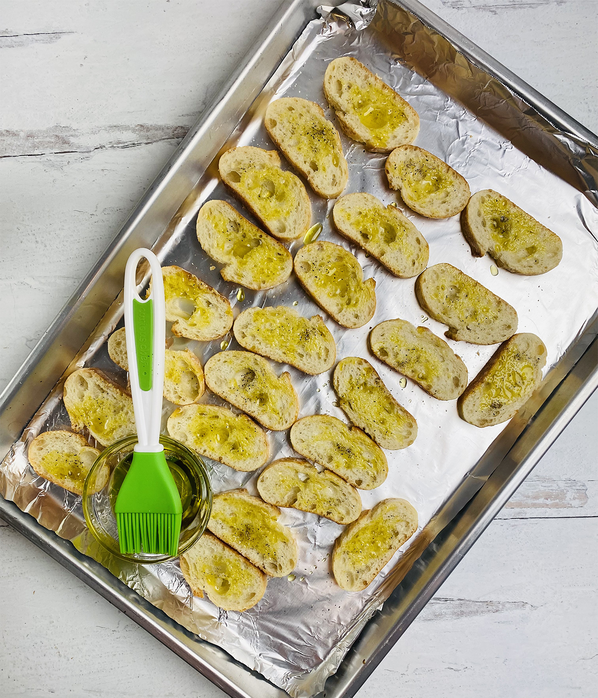 Crostini brushed with olive oil.