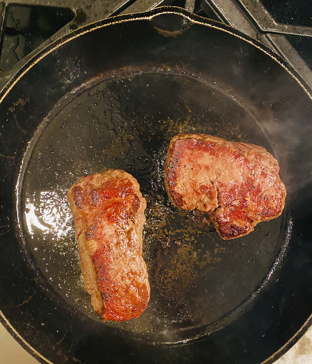 Filet cooking in a pan.