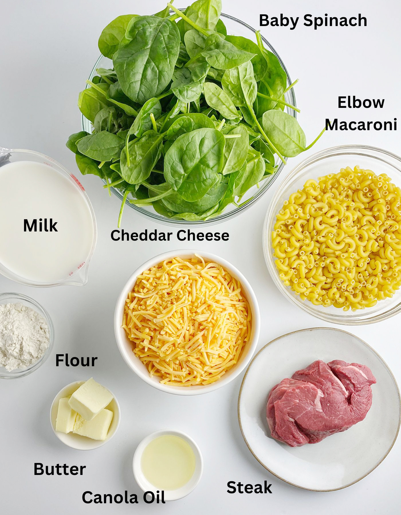 Ingredients for steakhouse macaroni and cheese on a white counter.