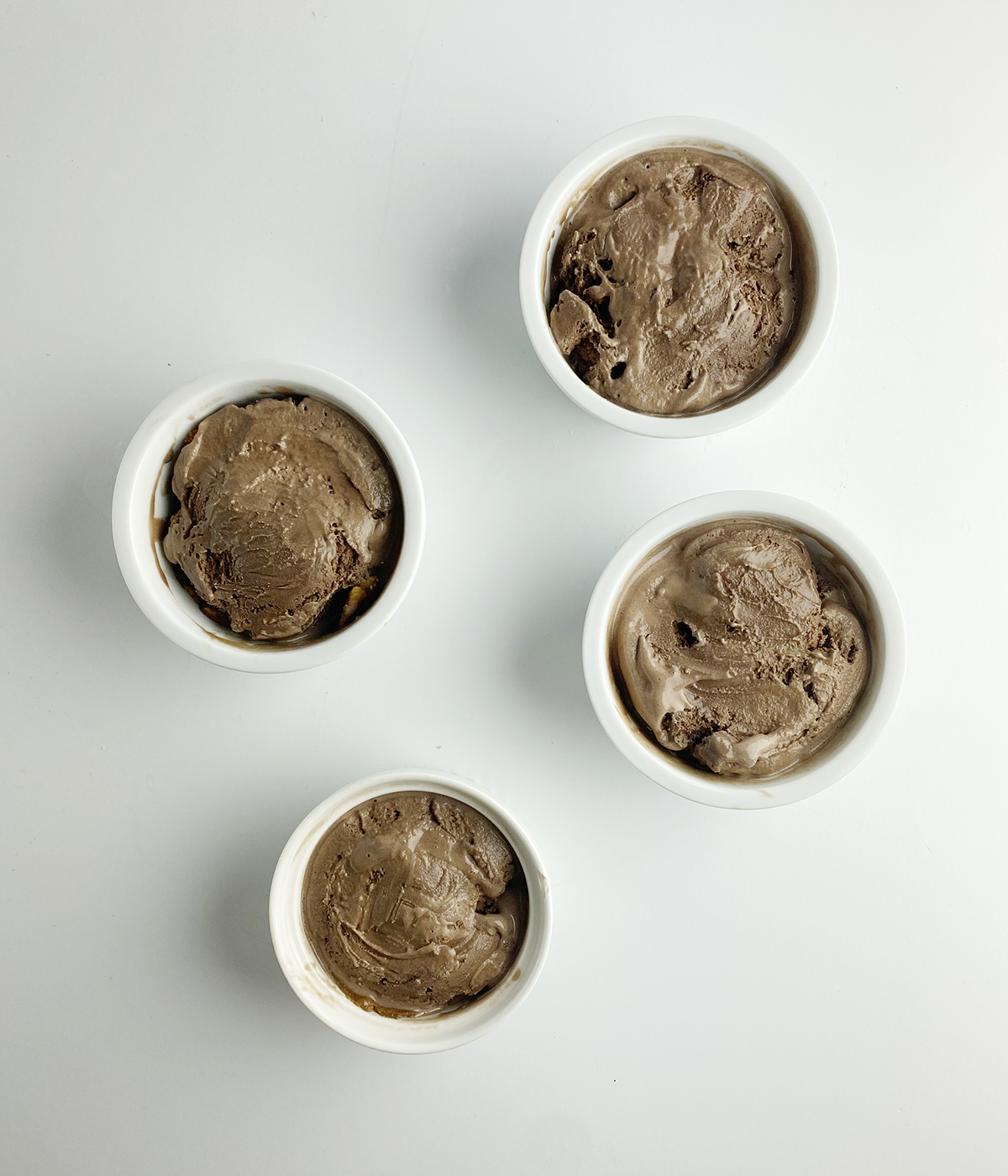 Ramekins filled with chocolate ice cream.