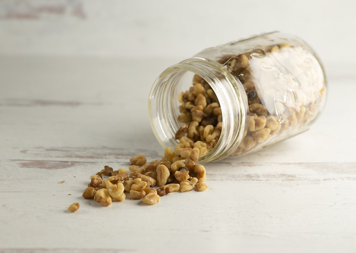 Walnuts spilling out of a jar.