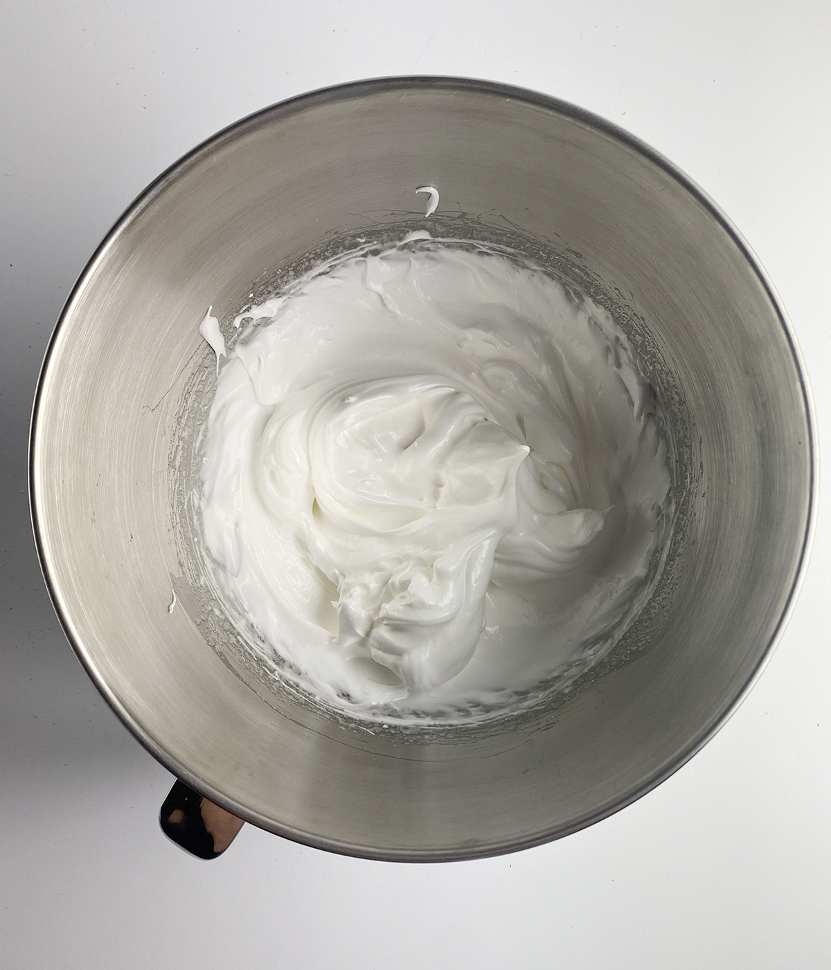 Whipped meringue in a mixing bowl.