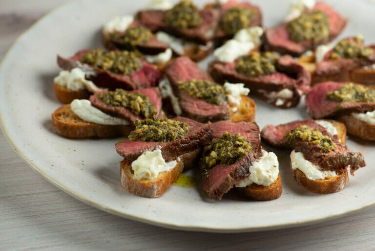 Filet Mignon Pesto Crostini on a plate.