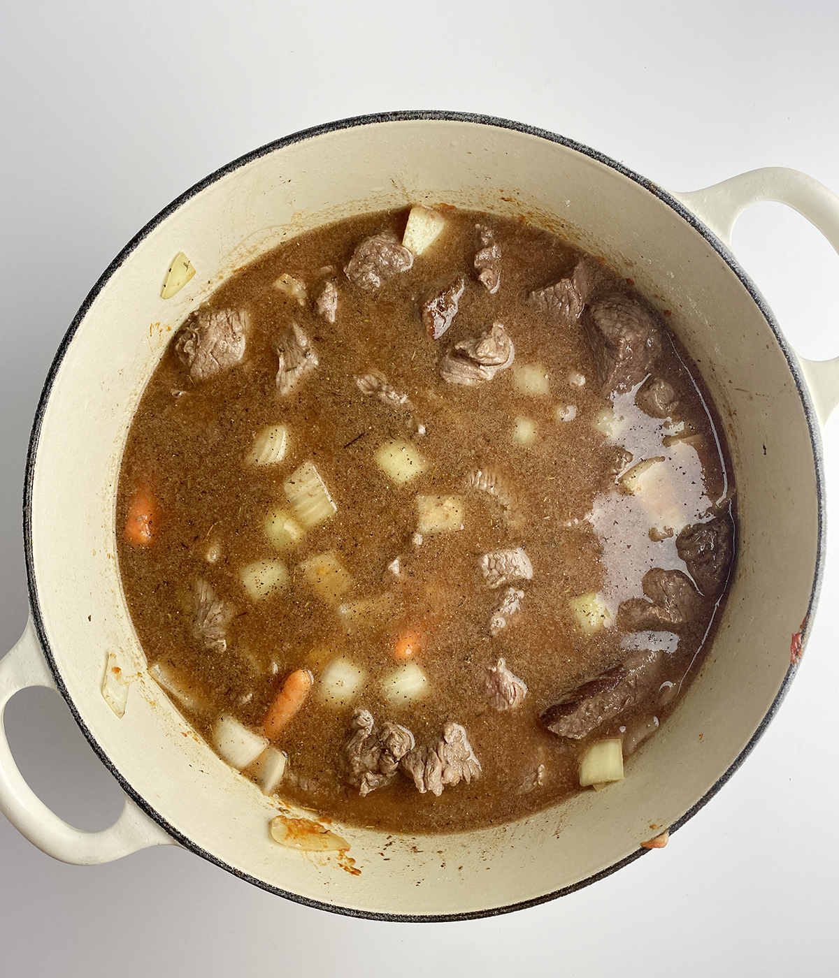 Beef stew ingredients in a pot ready to be cooked.