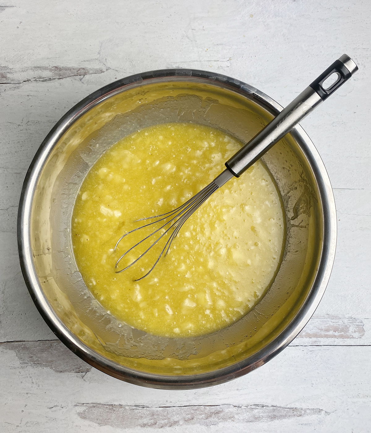 Butter and banana mixture in a mixing bowl.