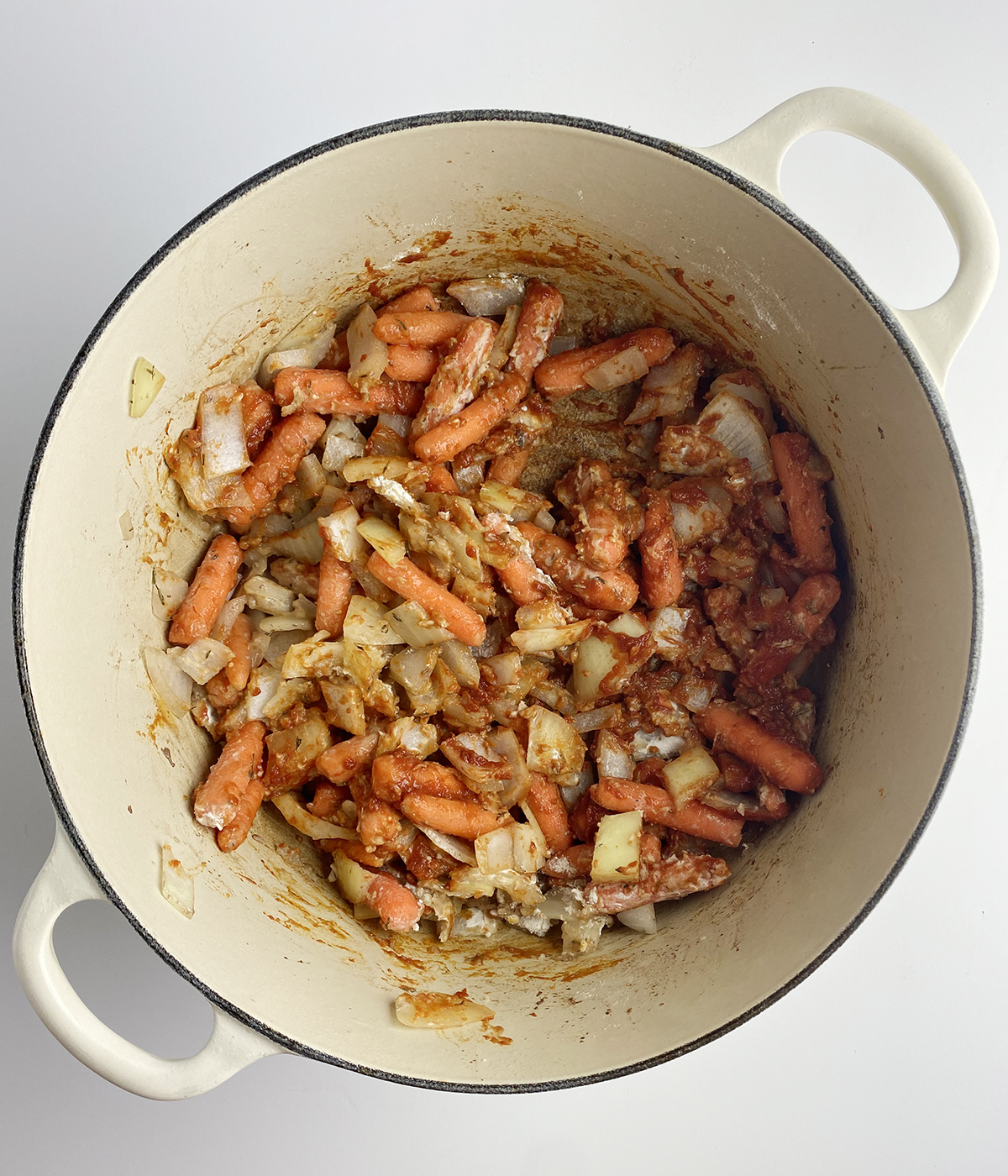 Cooked vegetables for beef dumpling stew in a pot.