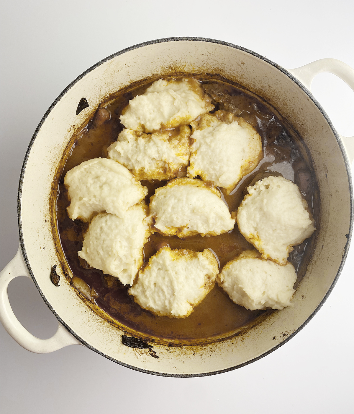 Dumplings in a pot of beef stew.