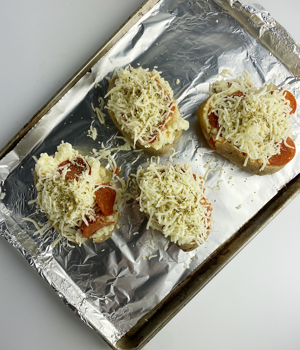 Stuffed pizza potatoes ready for the oven.