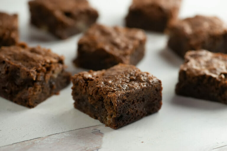 Banana brownies on a wooden counter.