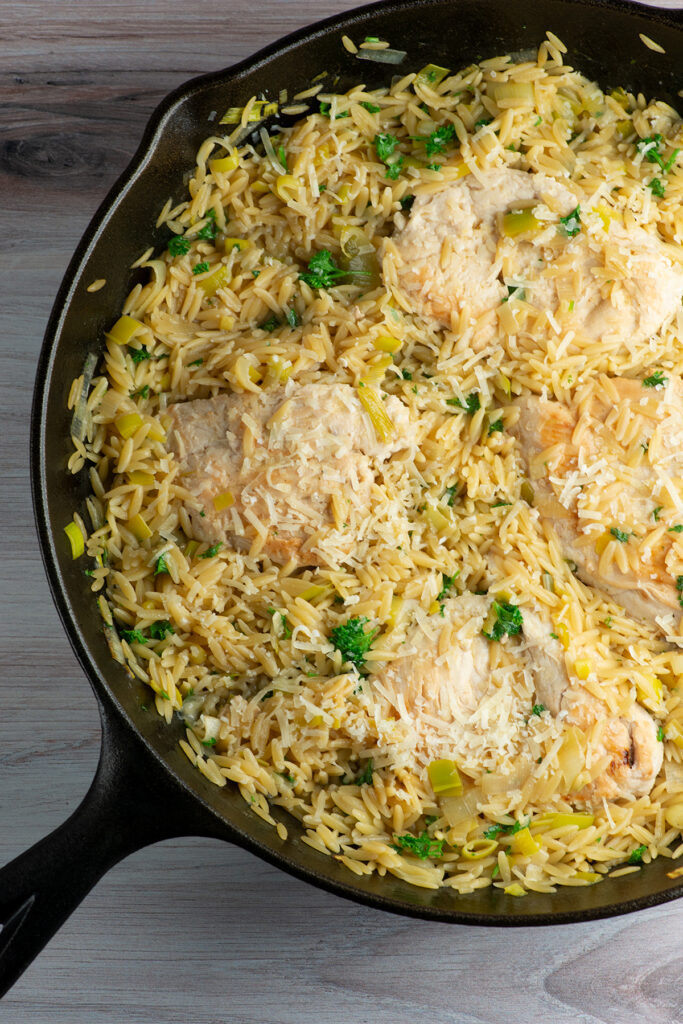 Easy one skillet lemon chicken with orzo in a skillet.