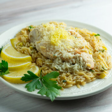 One skillet lemon chicken with orzo on a plate.