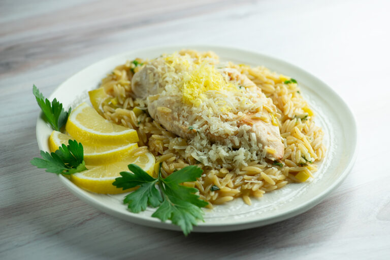 One skillet lemon chicken with orzo on a plate.