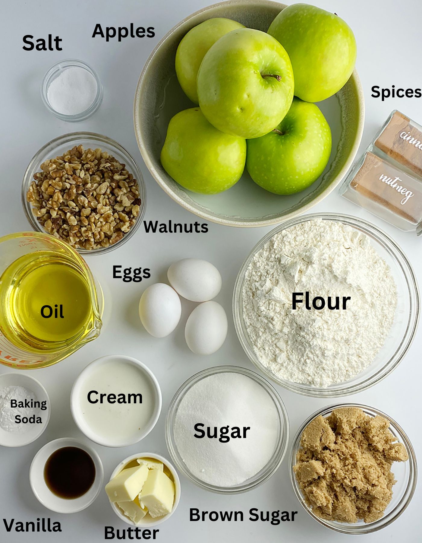 Ingredients for caramel apple cake on a white counter.