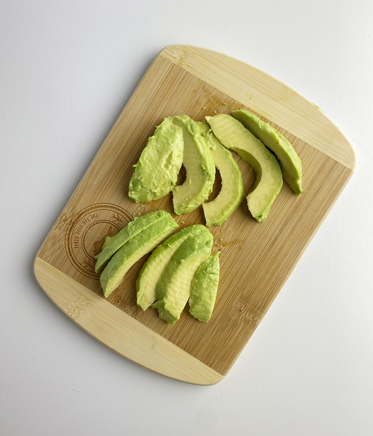 Sliced avocado on a cutting board.