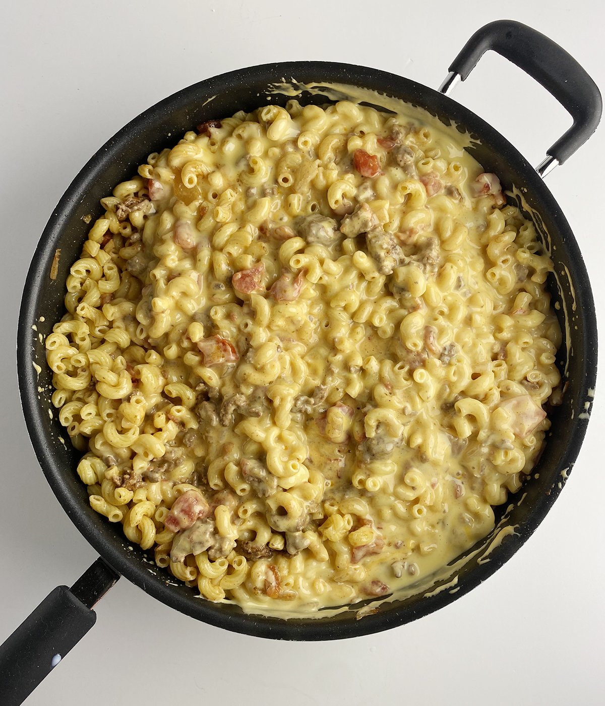 Taco macaroni and cheese in a skillet.