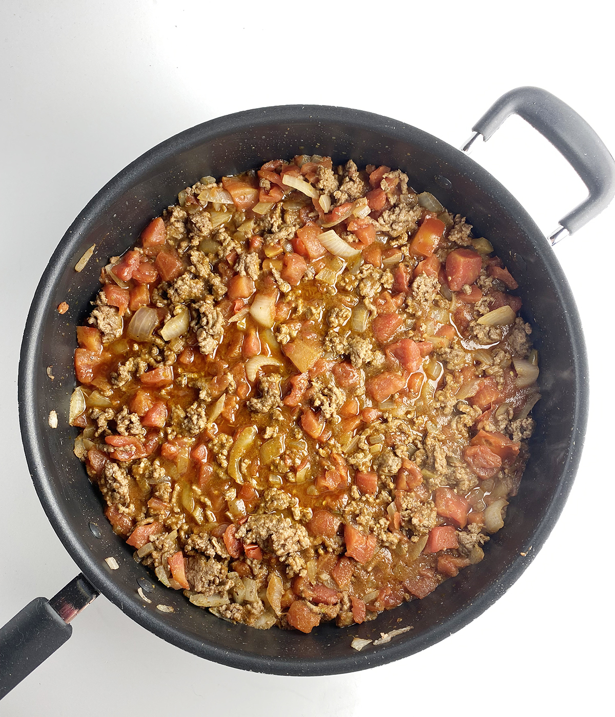 Taco meat cooking in a skillet.