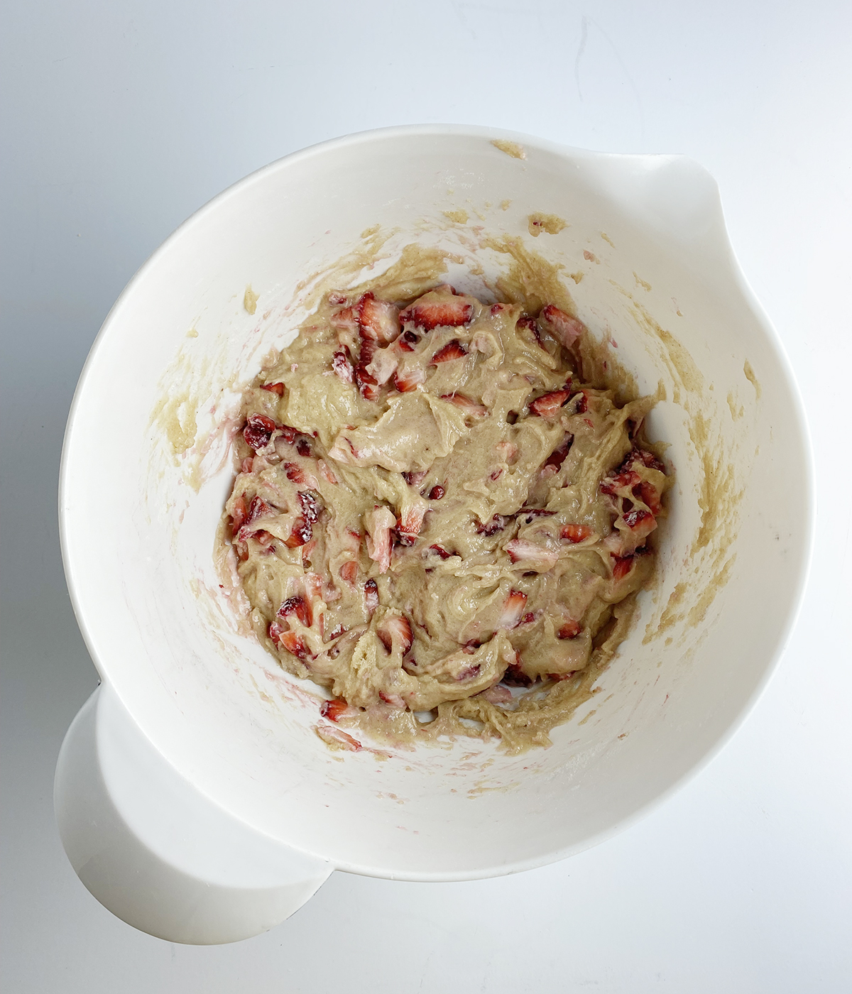 Strawberry crumble muffin batter in a mixing bowl.