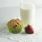 Strawberry crumble muffin with a glass of milk.