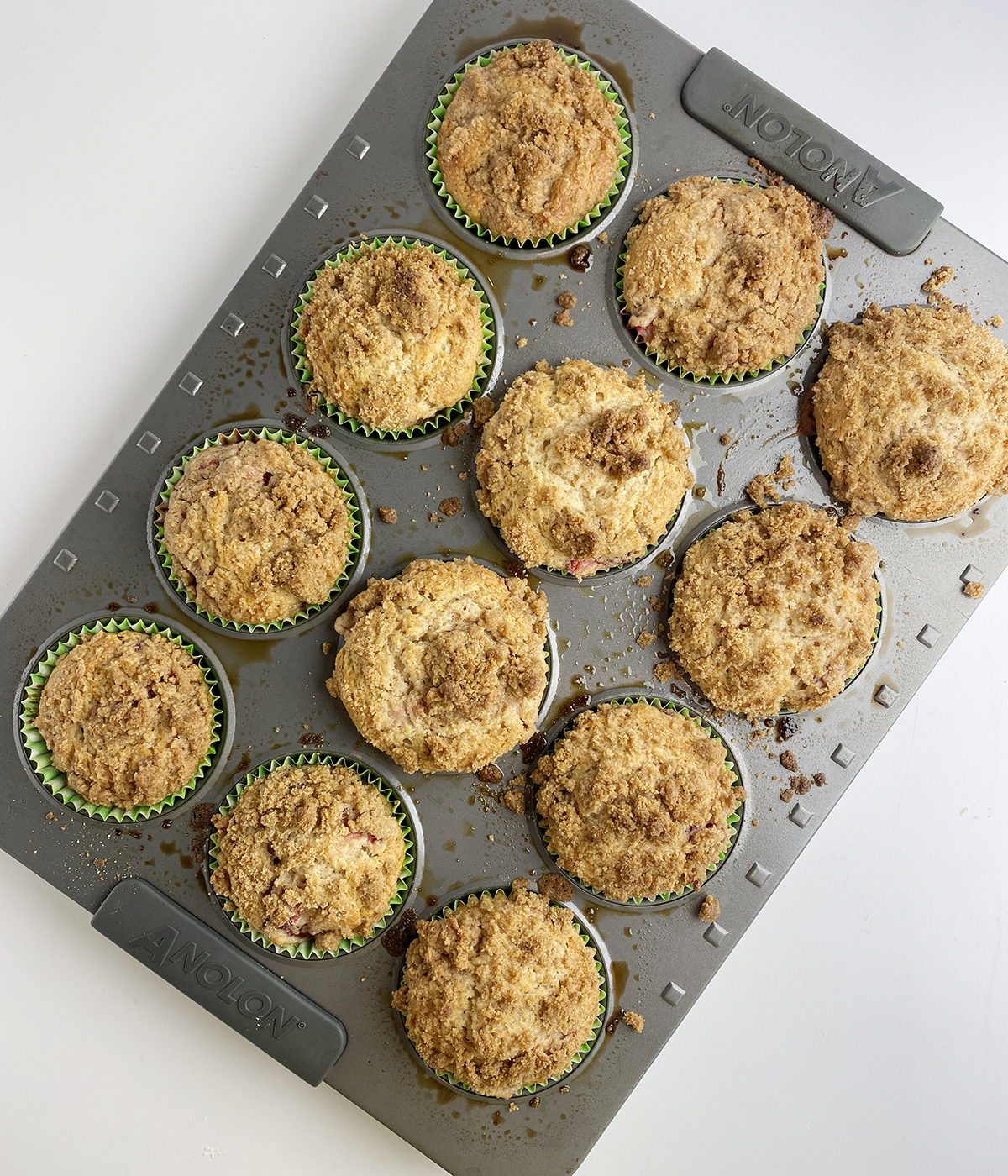 Strawberry crumble muffins in a muffin pan.
