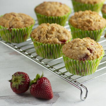 Strawberry crumble muffins on a cooling rack.