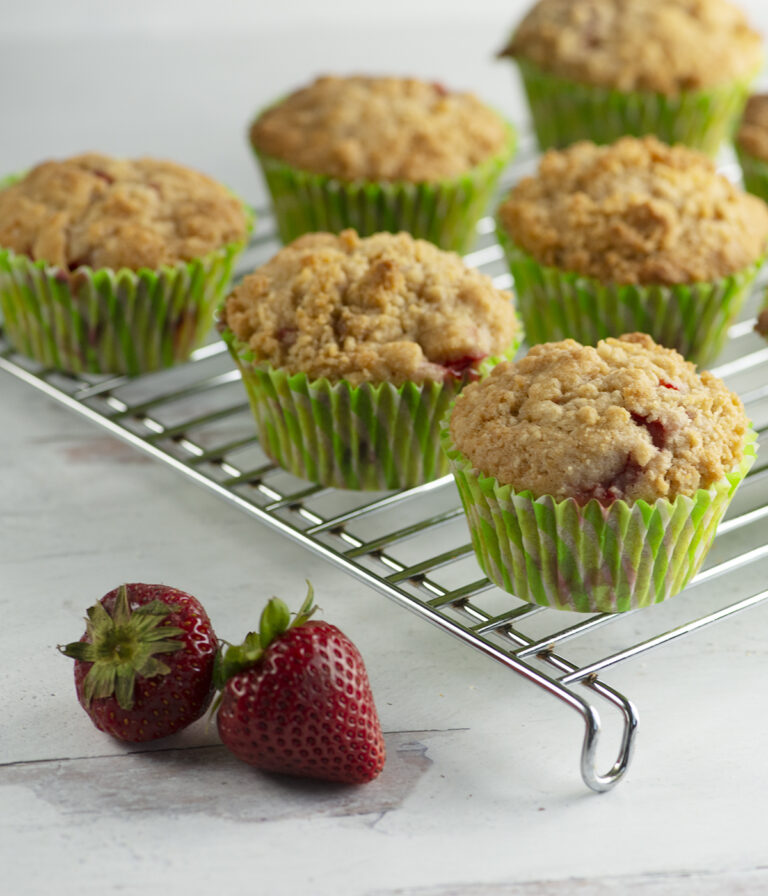 Strawberry crumble muffins on a cooling rack.