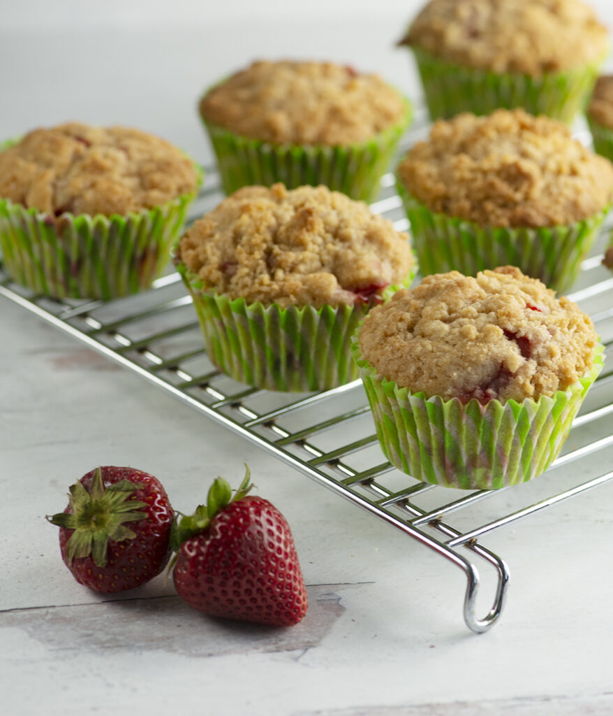 Strawberry crumble muffins on a cooling rack.