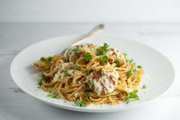 Spaghetti with Chicken Parmesan Meatballs on a plate.