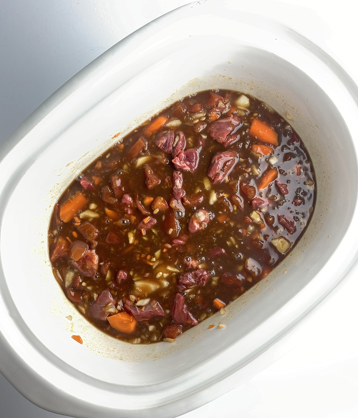 Beef bacon soup ready to be cooked in the slow cooker.