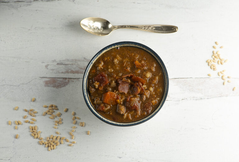 Beef barley soup in a bowl.