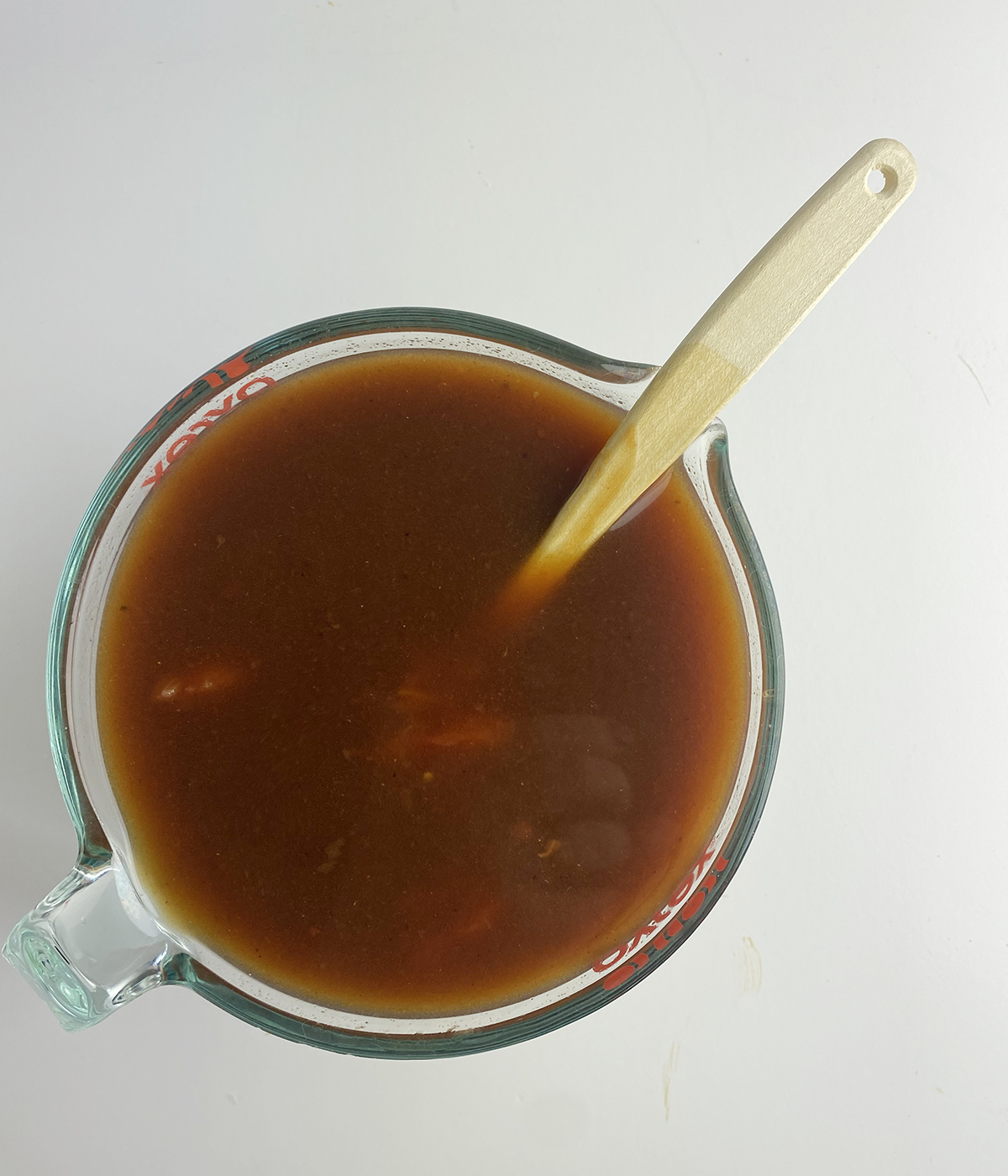 Beef broth and gravy mixture in a measuring cup.