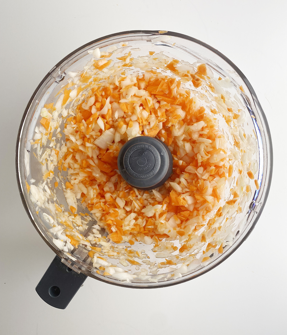 Chopped vegetables in a food processor.